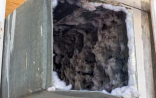 Clogged dryer vent filled with lint buildup