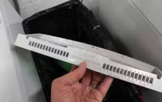 Person holding dryer lint filter for cleaning