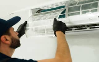The Guide to HVAC Care for Summer—Action Air Duct's tech cleans AC filters to boost performance and keep your home cool all season.
