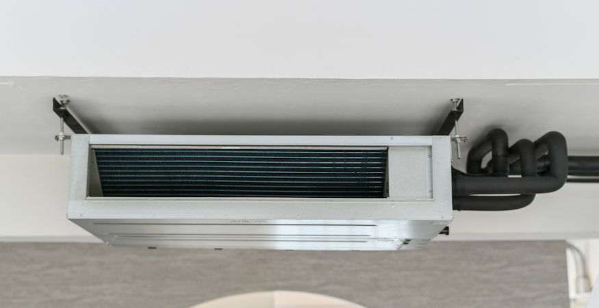 The Role of UV Lights in Keeping Your Ducts Clean Ceiling-mounted air conditioning unit with exposed pipes