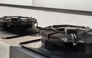 Two outdoor air conditioning units on rooftop